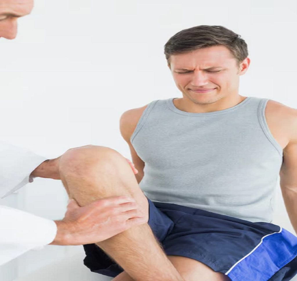 displeased young man getting his leg examined 13339 293690